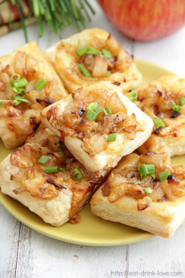 Little baked apple tarts on a wooden table.