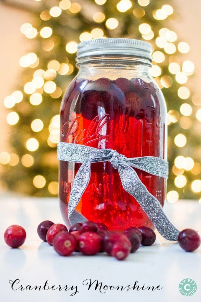 Cranberry Moonshine is a delicious gift you can make and give away! The red color is so gorgeous and you can dress up the mason jar with a glittery bow!