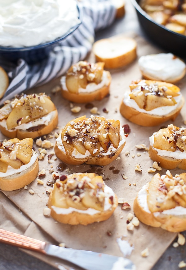 Pear crostini on a wooden tray.