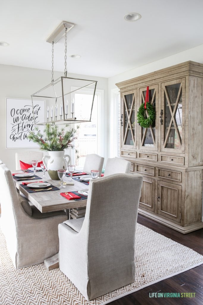 Gorgeous dining room with linen slipcovered chairs, reclaimed wood table and beautiful wood hutch. Love the Darlana Linear Pendant Chandelier over the table!