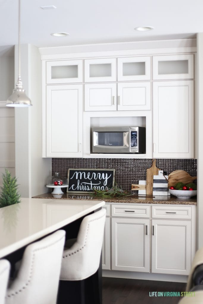 Christmas kitchen with wood Merry Christmas Sign and red and green accents.