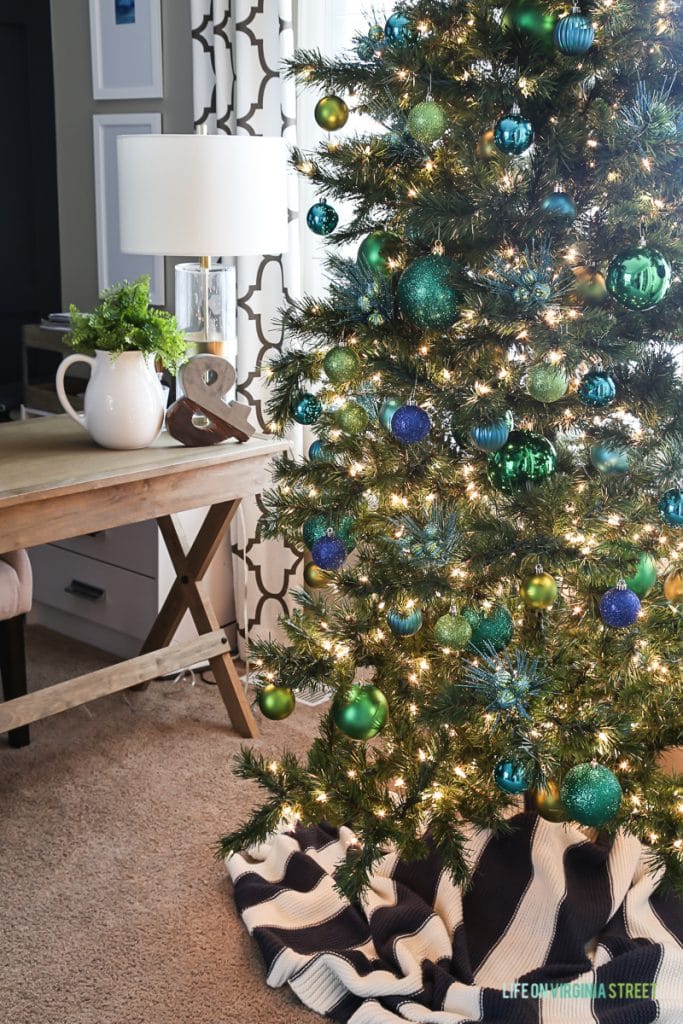 Green and blue ornaments on Christmas tree.