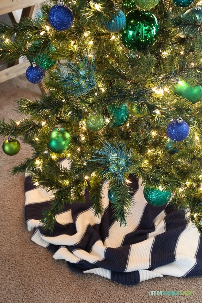 A blue and white skirt around the Christmas tree.