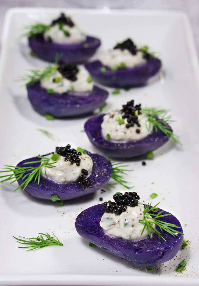Purple potato bites with creme fraiche on top and caviar as well.