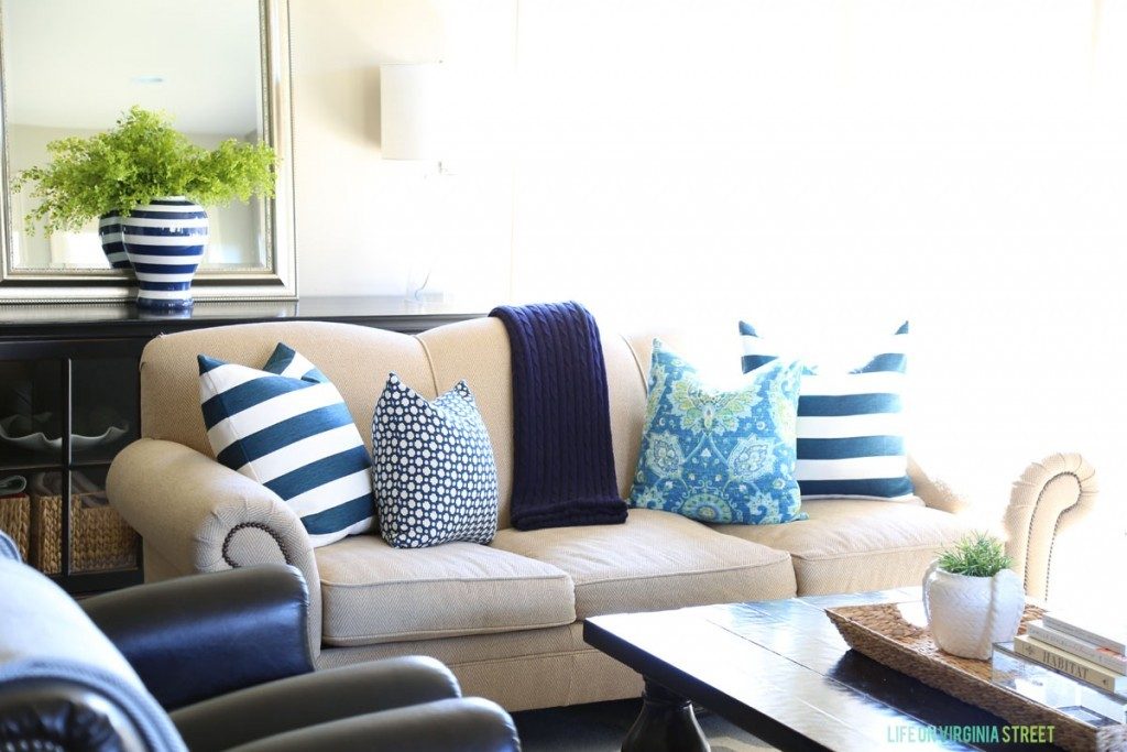 Spring living room with navy blue striped pillows and aqua suzani pillows.