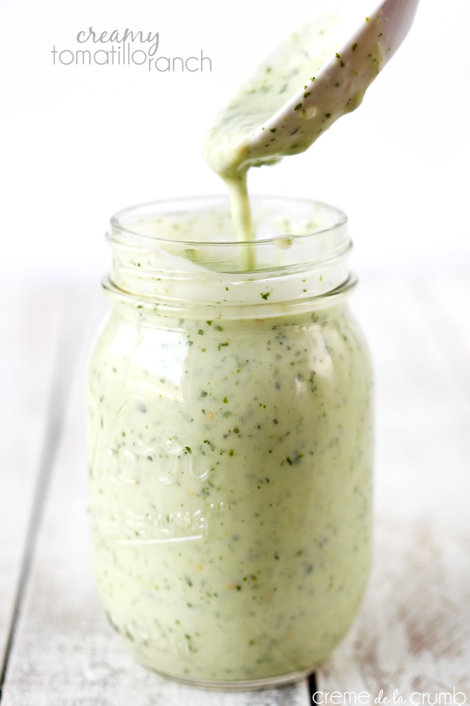Tomatillo ranch dressing in a mason jar with a spoon.