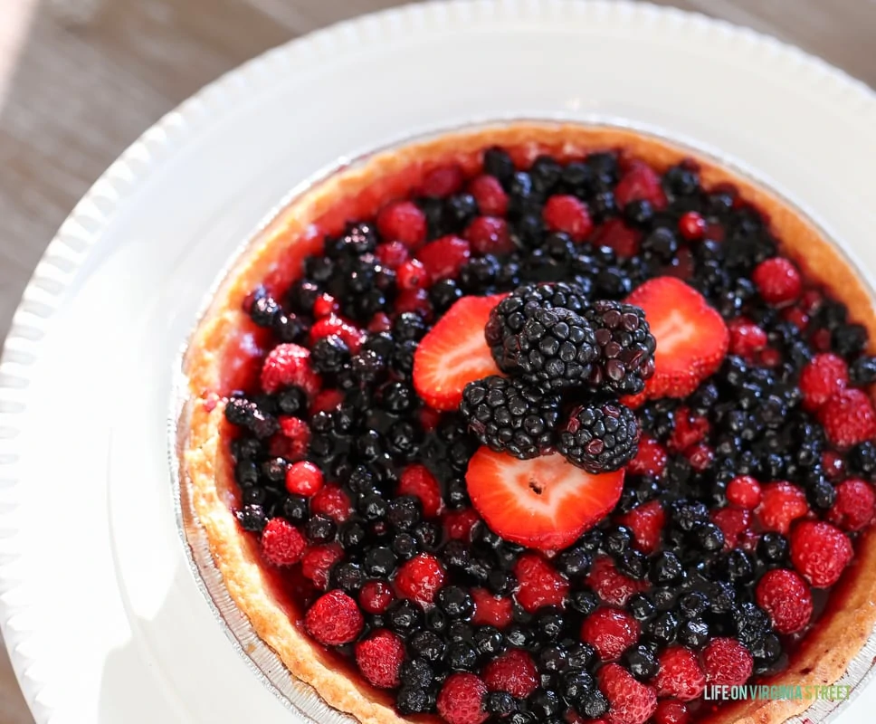 A large berry fruit tart flan on the table