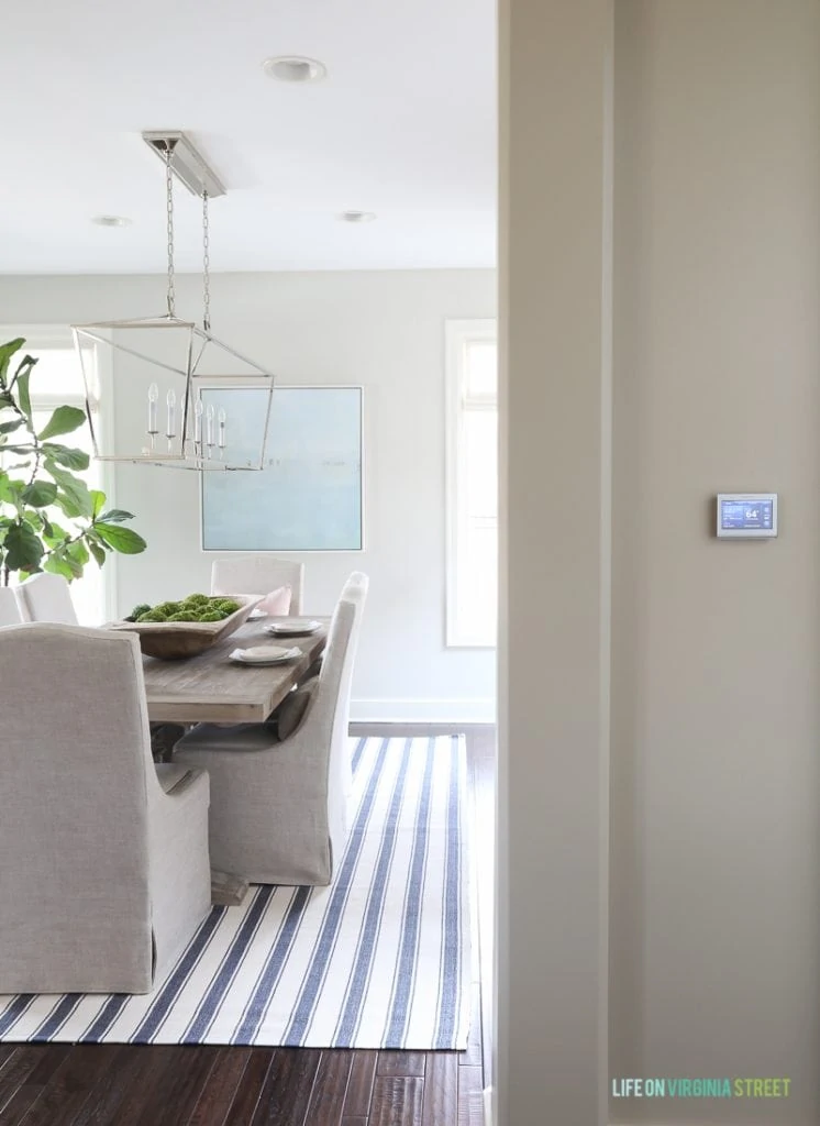 Coastal inspired dining room with the chrome Darlana Linear Pendant. This post shares excellent sources for nearly identical look for less lighting options!