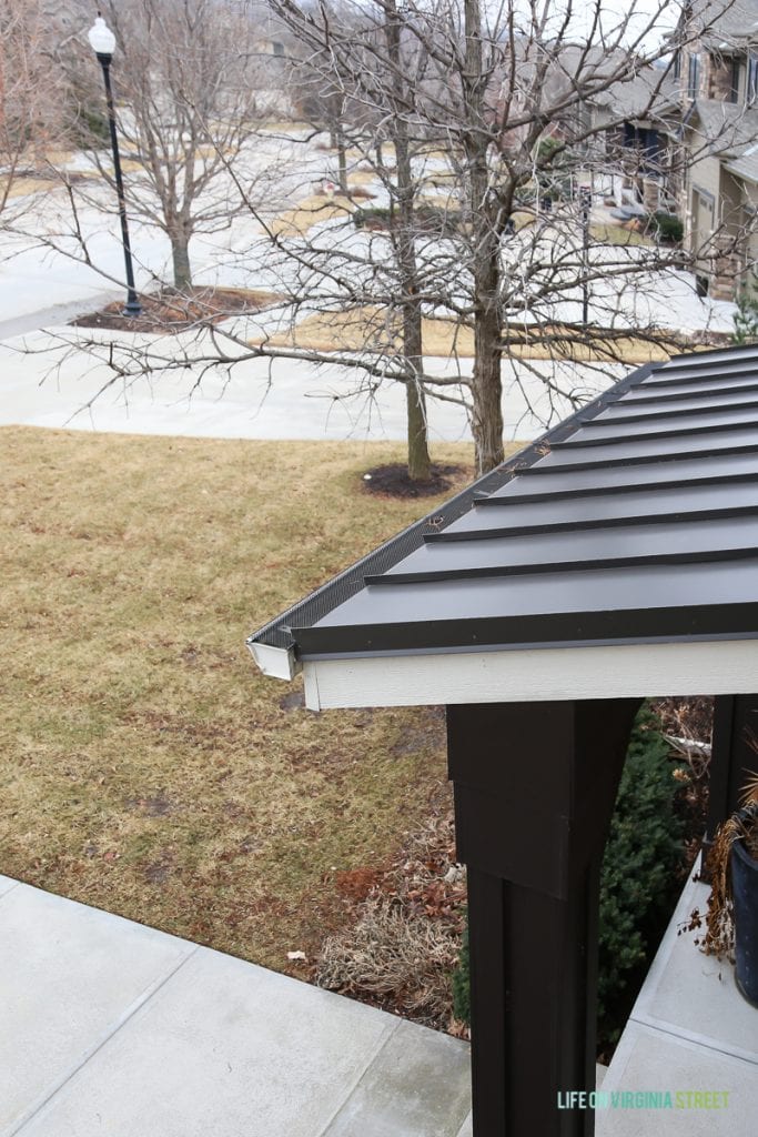 A metal roof with trees beside it.