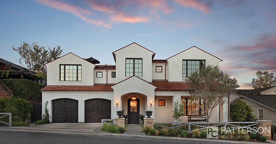 White Brick House with Black Window Frames via Patterson Custom Homes