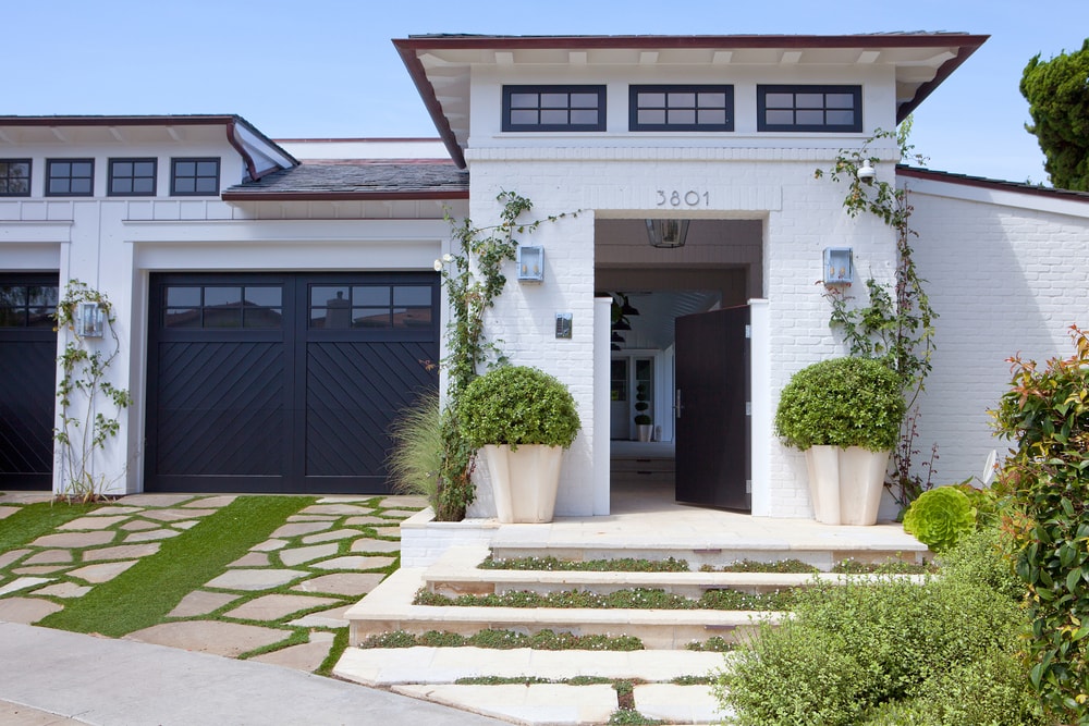 White exterior with Black window frames and Black garage via Molly Wood Garden Designs