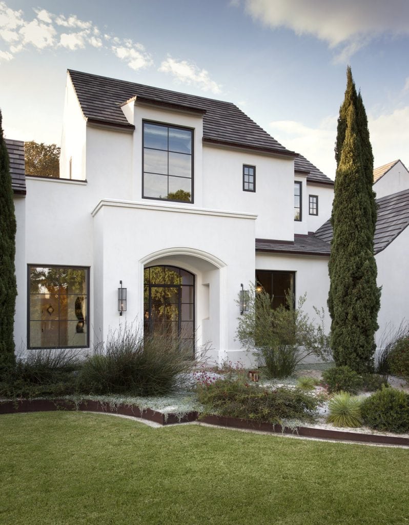 White exterior with black window frames via Ryan Street & Associates