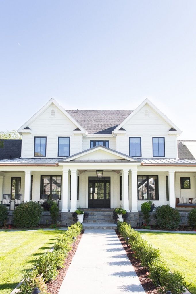 White house with black trim and metal roof via Studio McGee