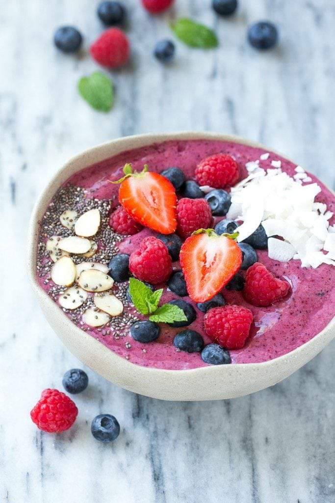 Quick and easy acai bowl that has blueberries, raspberries, and shaved coconut.