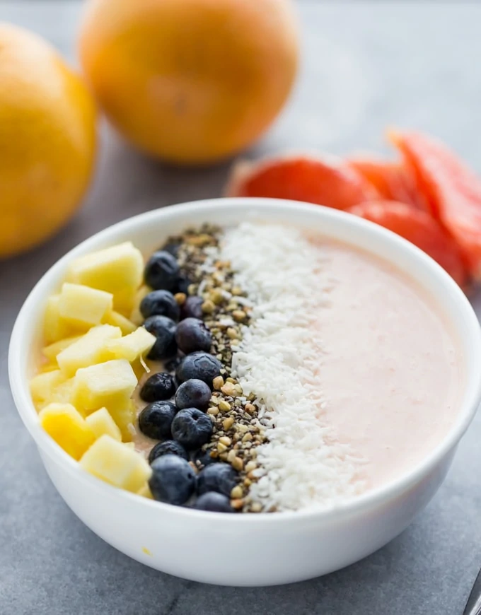 Grapefruit smoothie bowl with blueberries on top.