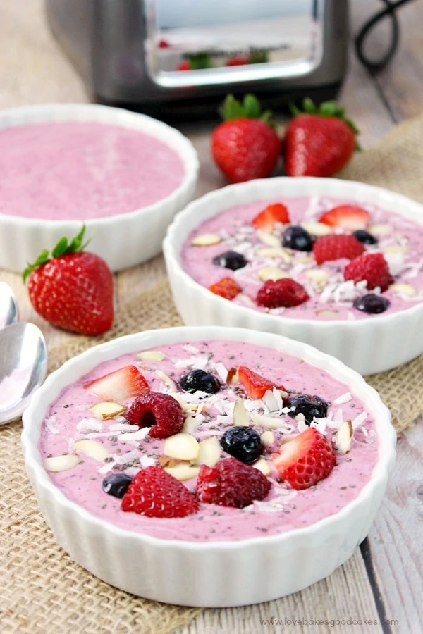 Mixed berry smoothie bowl that have strawberries and blueberries in the smoothie.