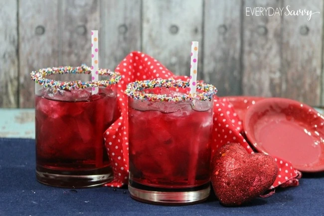 A strawberry Valentine cocktail with a candy rim.