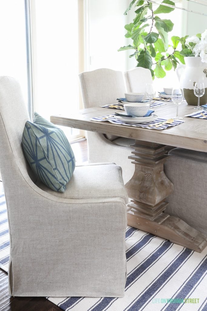 The Easter table with one linen chair askew from the table and a blue cushion on the chair.