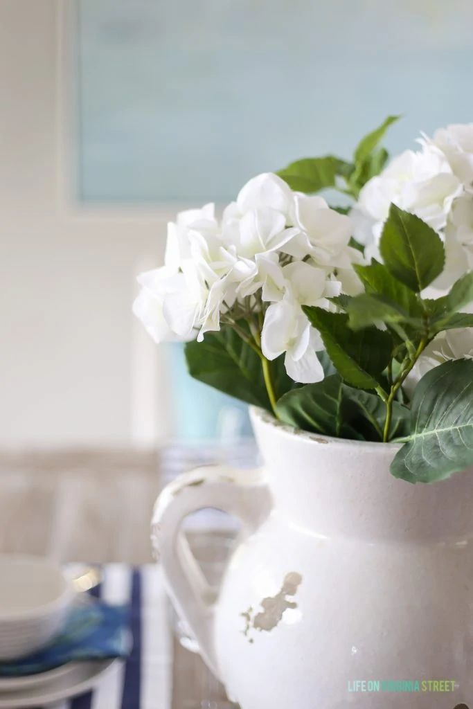 Faux hydrangeas in a coastal Easter dining room.