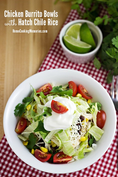 A chicken burrito bowl on a red and white checkered table cloth.