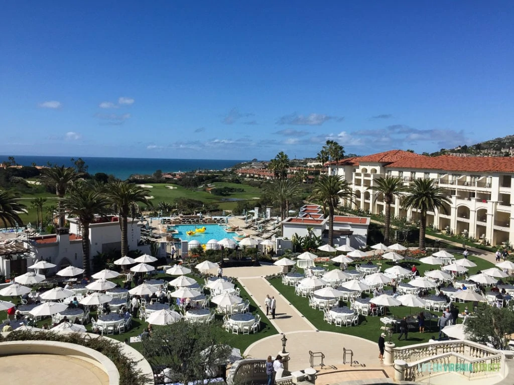 A view of the resort overlooking the pool with small tents set up on the grassy area.