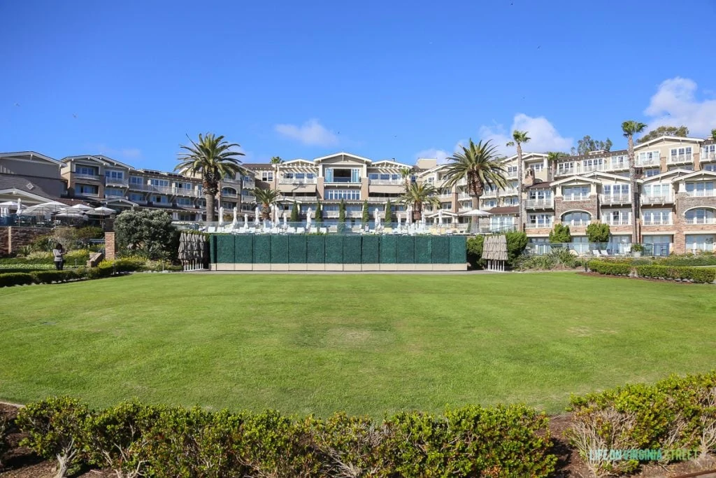 The gorgeous Montage Hotel in Laguna Beach with a large grassy area in the back.