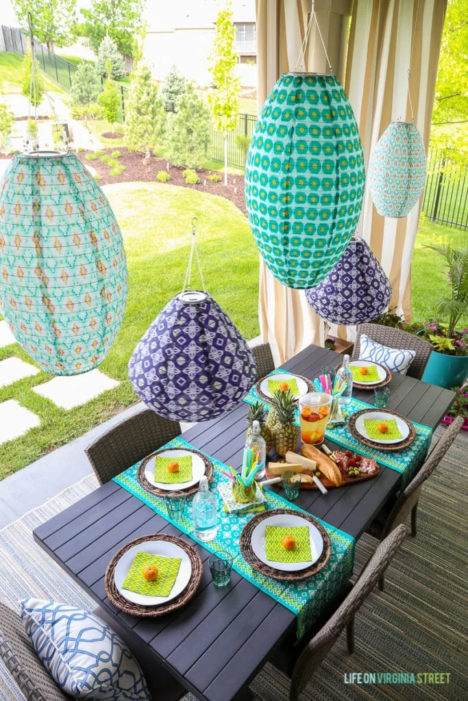 An aerial view of the table with the bright lanterns, and the table decorated for guests.