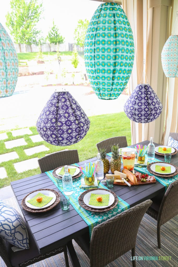  Love the colorful outdoor lanterns, pineapple centerpiece and turquoise table runners on the outdoor table.
