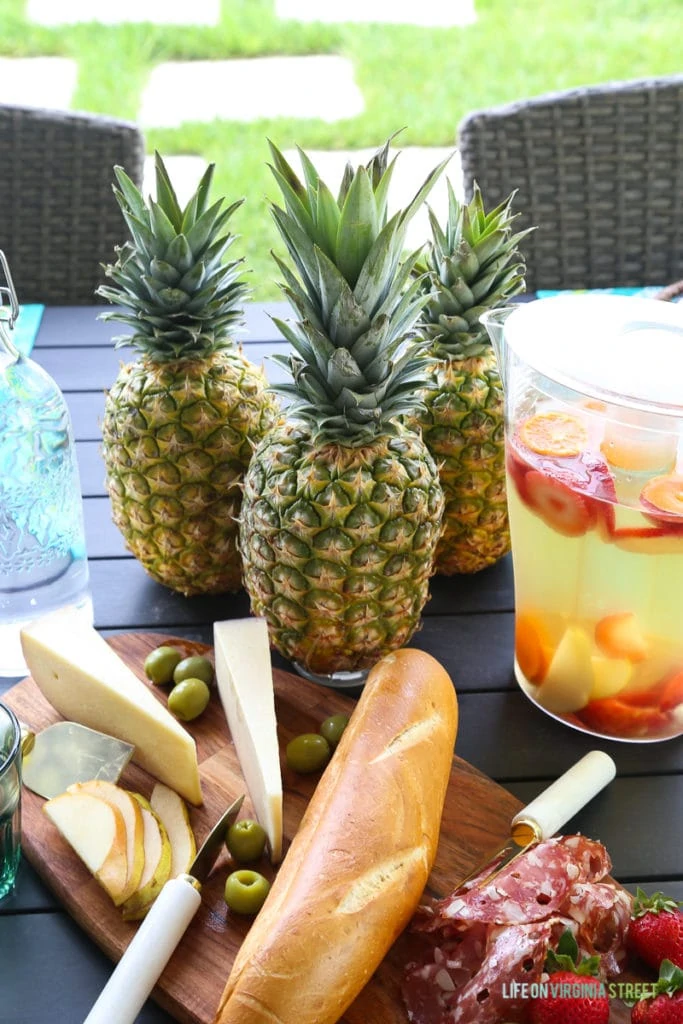 Three pineapples in the centre of the table.