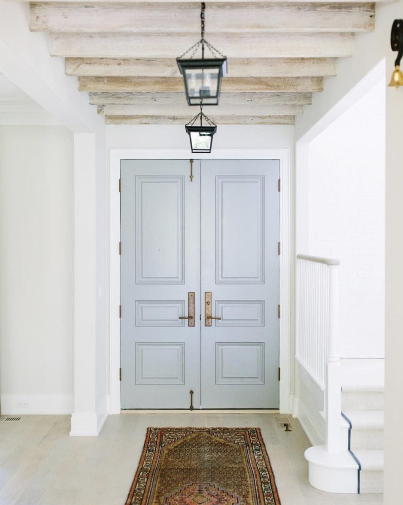 Benjamin Moore Cape May Cobblestone via Kate Marker Interiors. Love the black lanterns, light wood floors and ceiling beams.