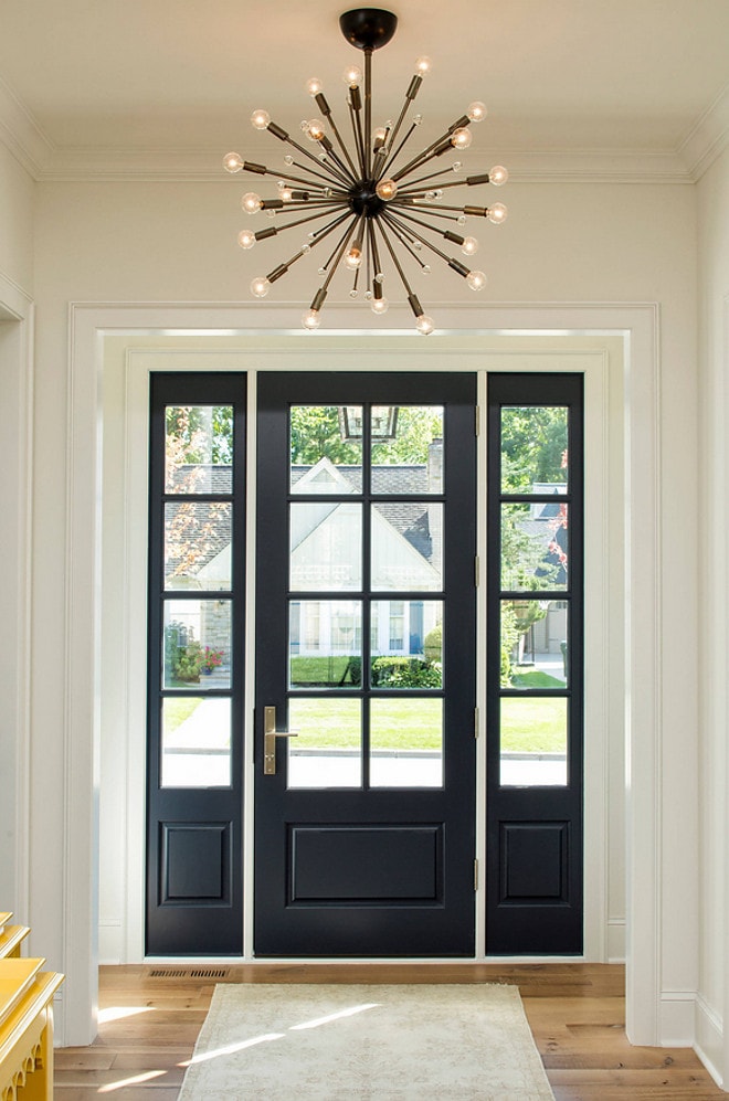 Benjamin Moore Hale Navy interior front door with a large brass light fixture above it.