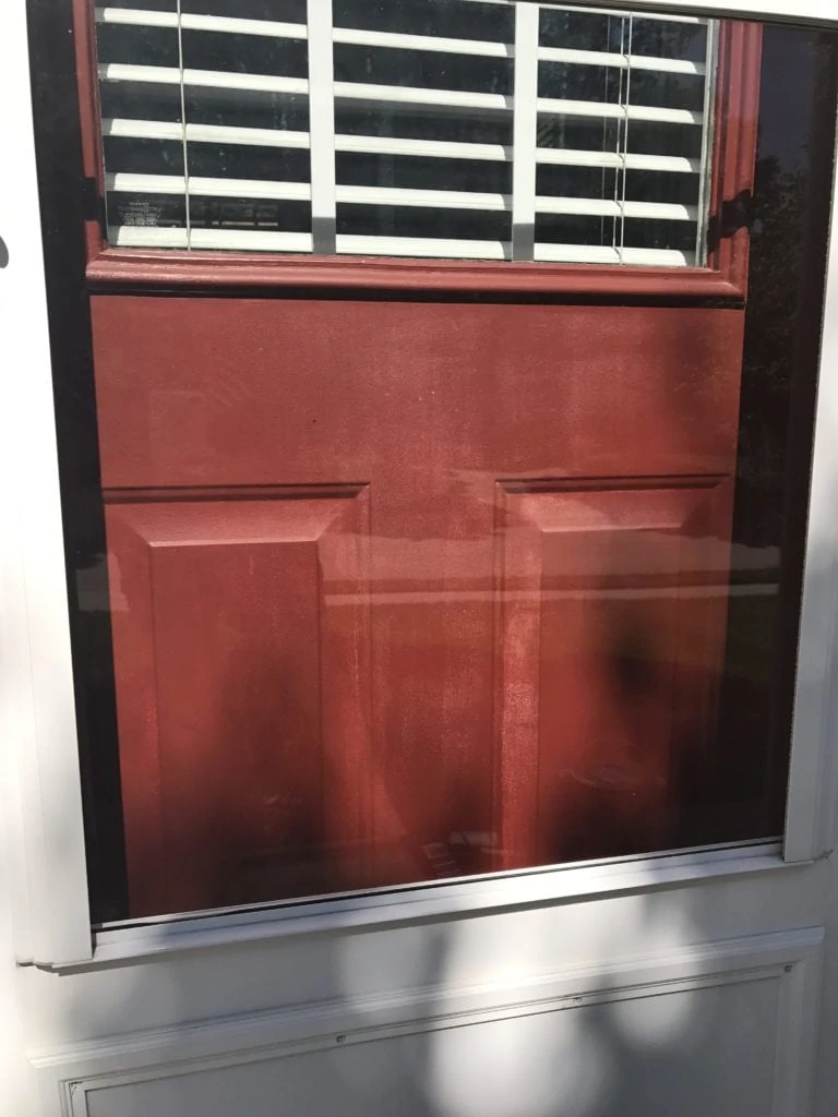 The streaked paint on this door was obvious even through the screen.