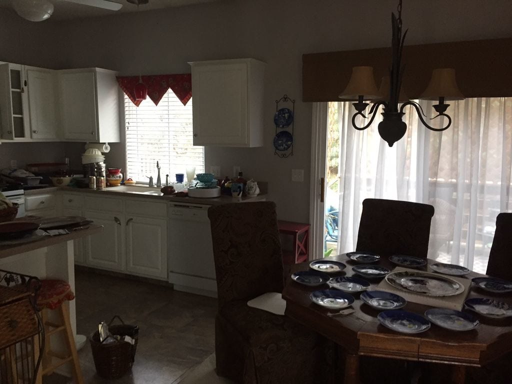 A dining room table with lots of plates on it.