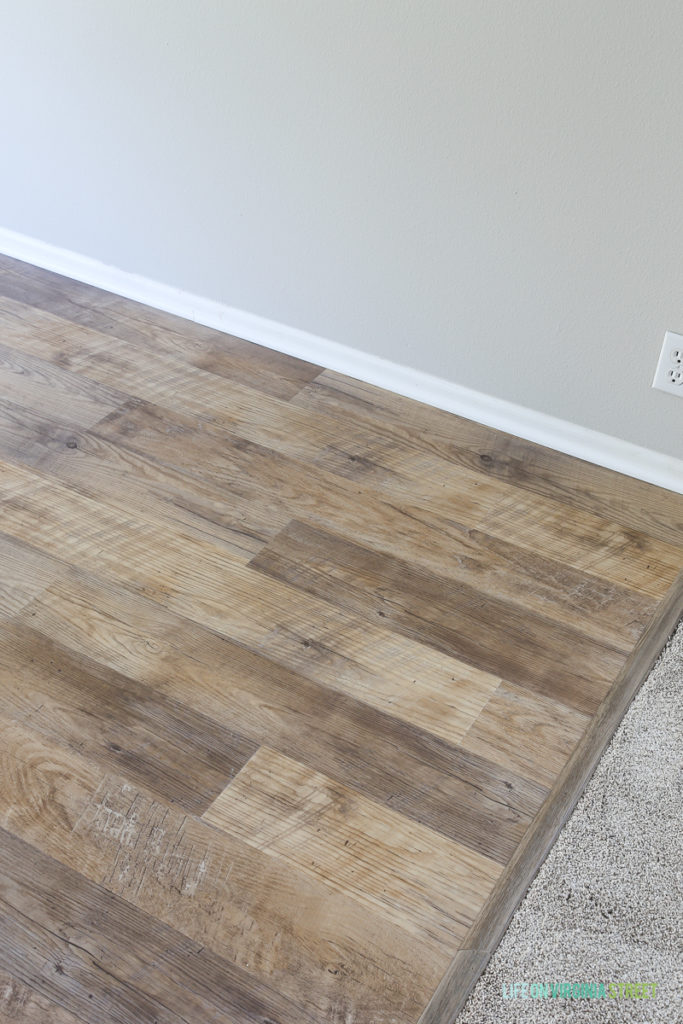 Rental house kitchen and dining makeover. Flooring is Mannington Adura Max® Plank Dockside Sand and wall color is Sherwin Williams Agreeable Gray.