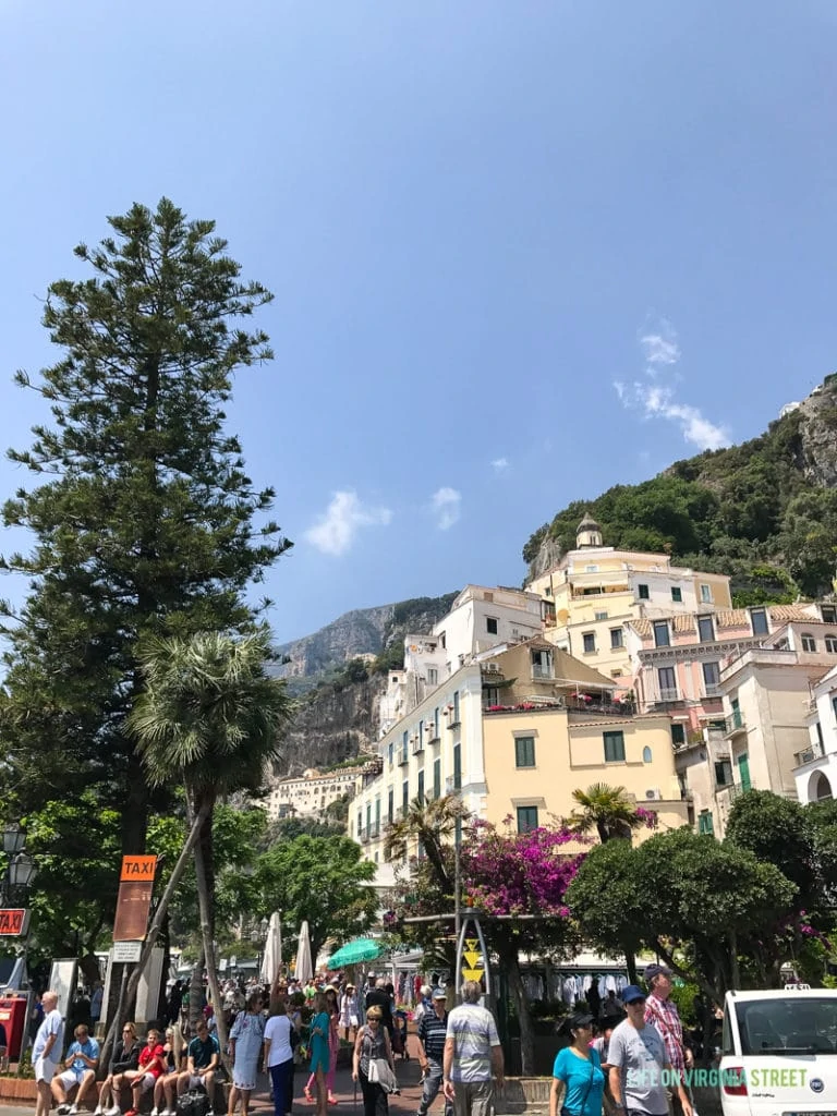 The city of Positano with lots of people in the square.