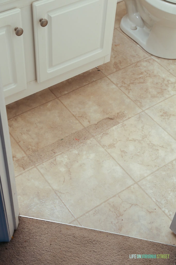 Badly worn linoleum in the bathroom.