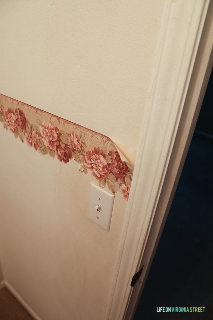 Peeling floral wallpaper in the bedroom.