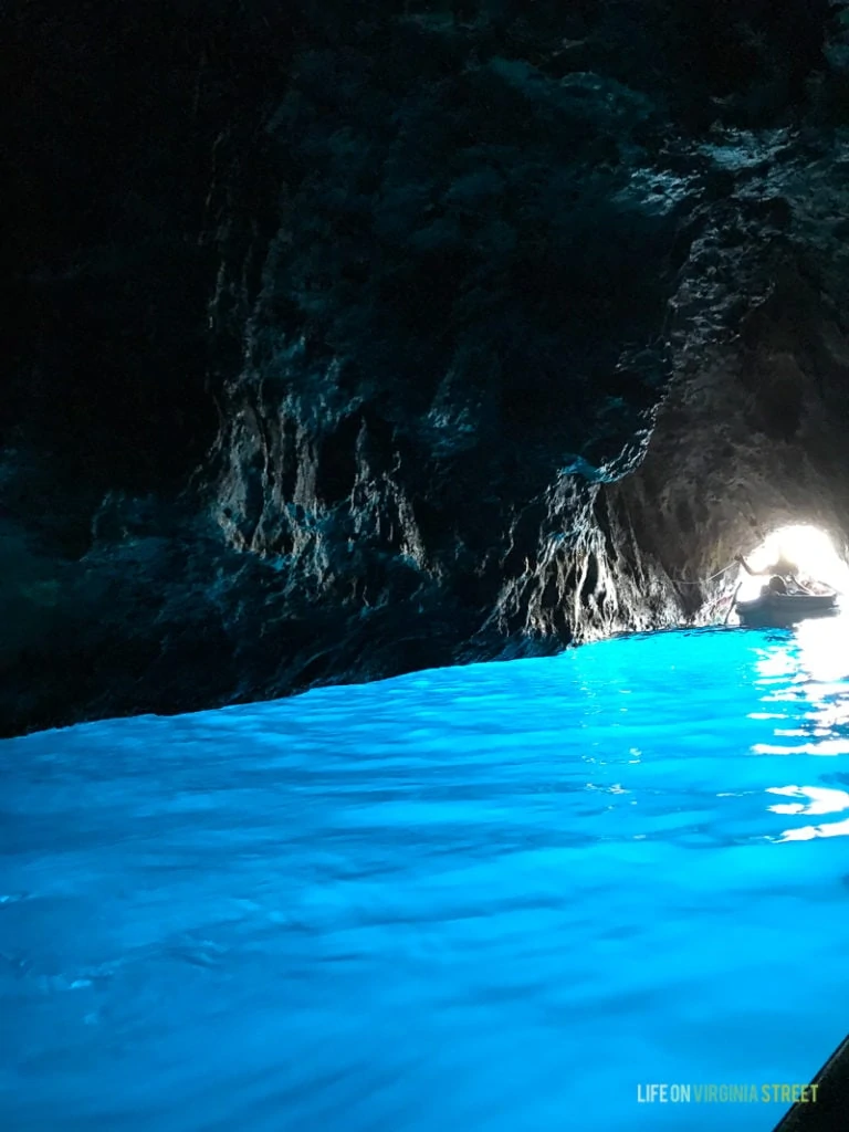 A cave with very blue water.