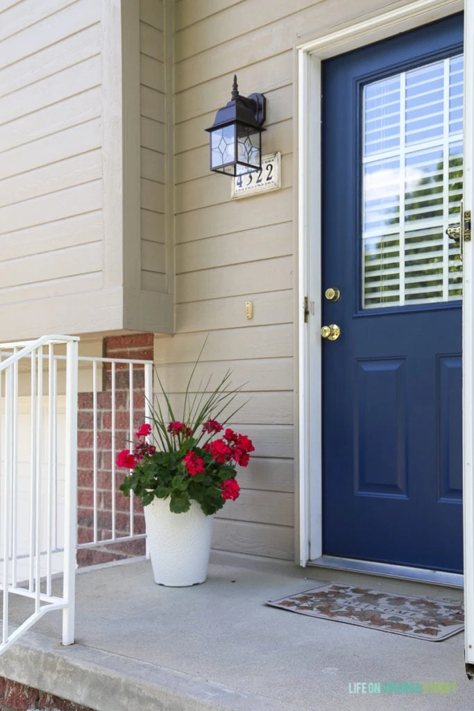 Adding some bright pink flowers and a great new light fixture was a great way to add curb appeal.