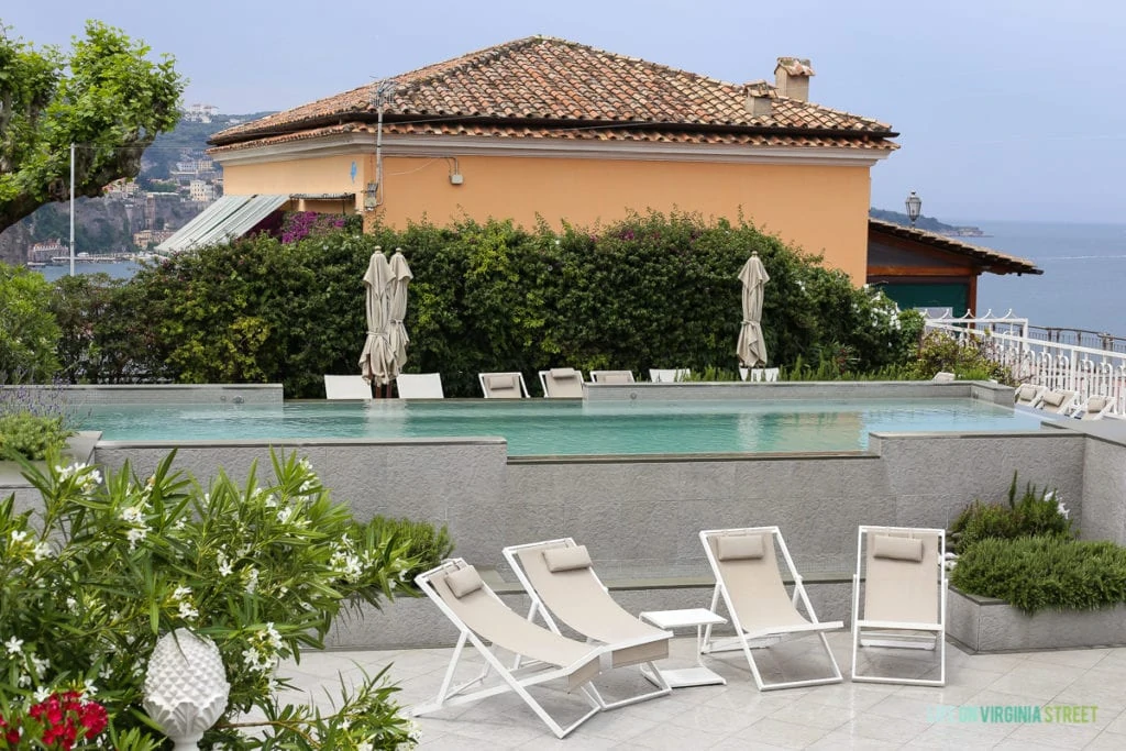 White lounge chairs beside the hotel pool.