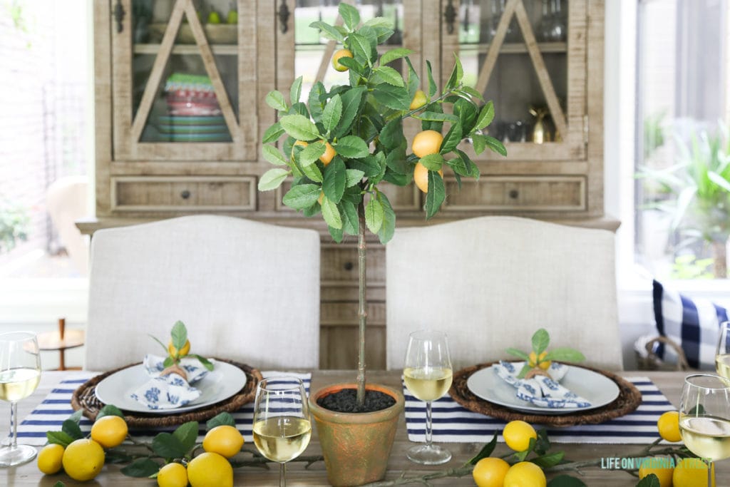 A wooden reclaimed hutch is behind the table in the dining room.