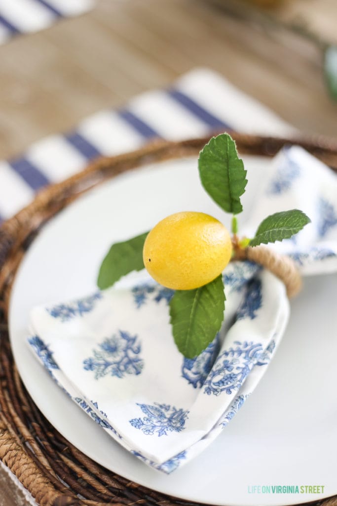 Lemon napkin rings around blue and white napkins.