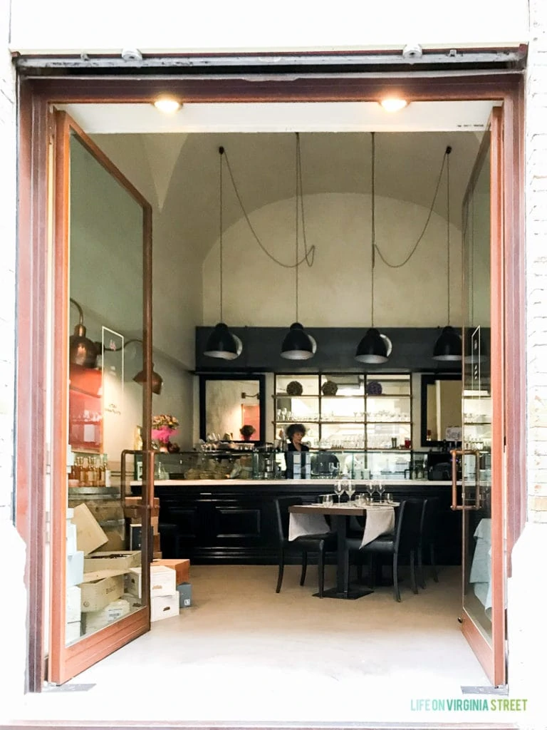 Looking into the restaurant with a woman behind the counter.
