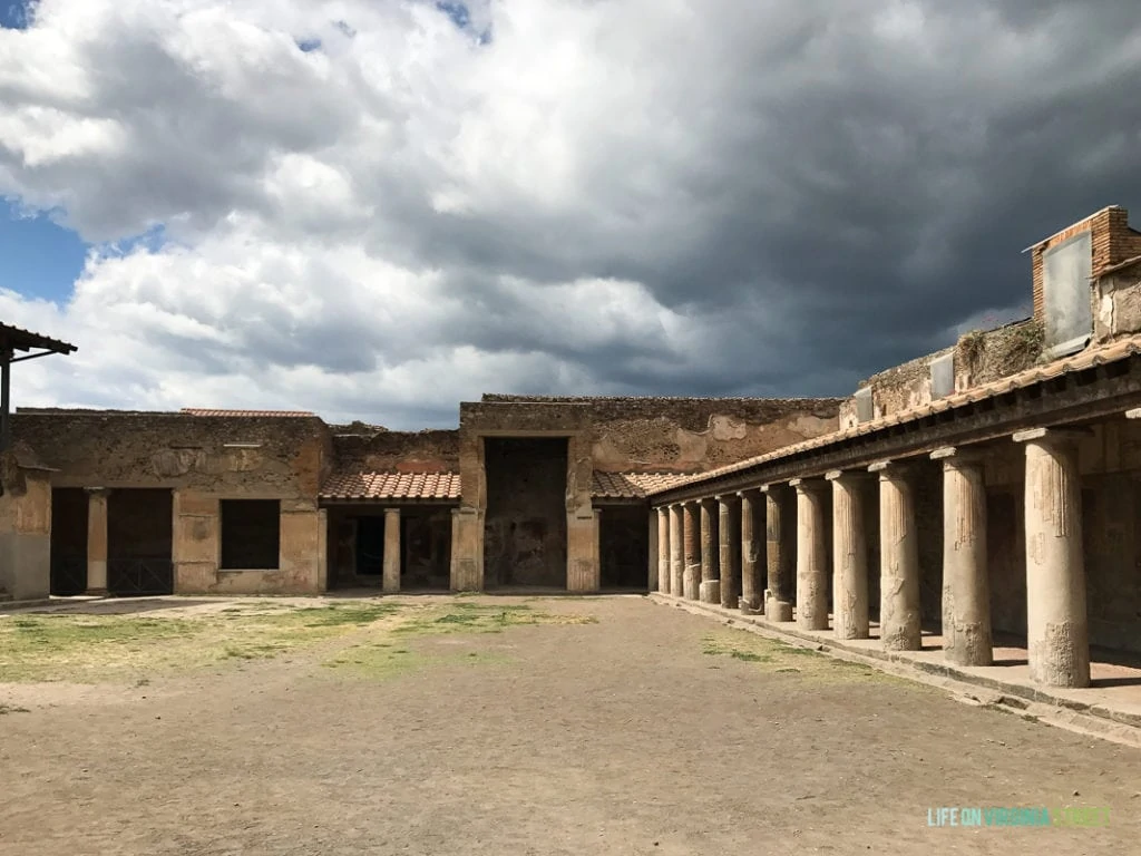 An old rustic building with pillars and stone.