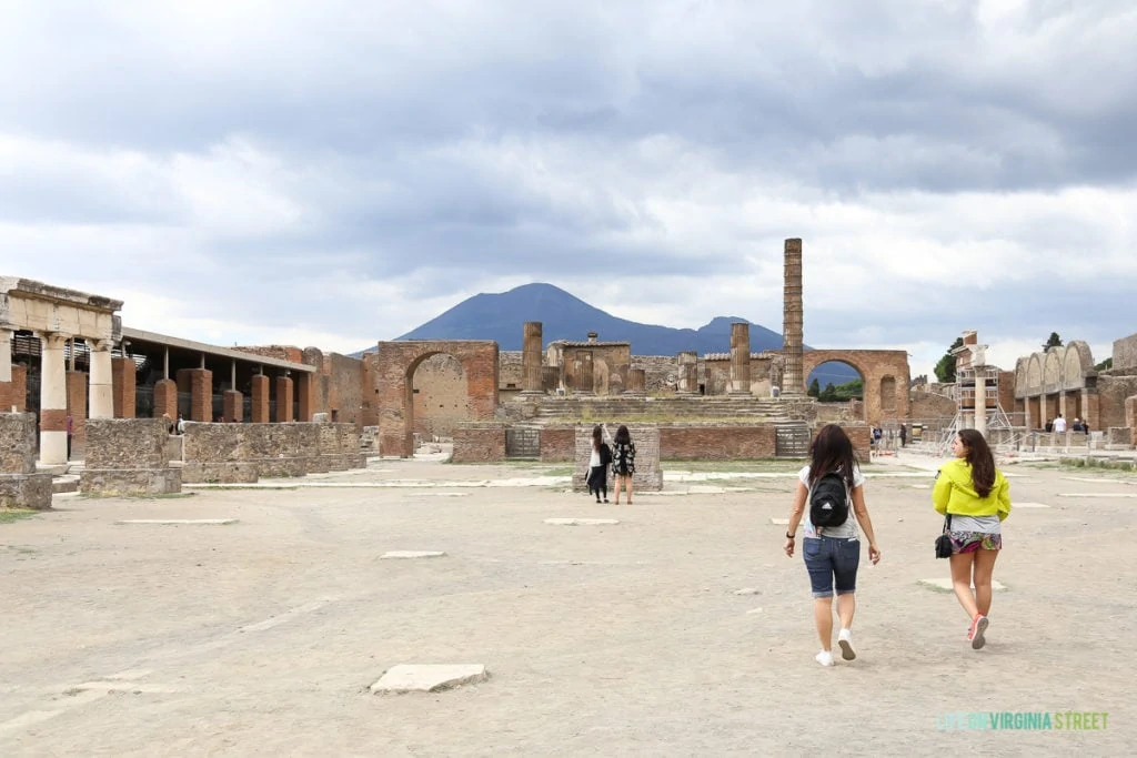 A main square in Pompeii with a couple of tourists there.