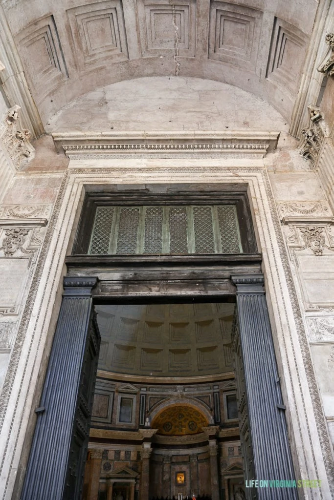 The large doorway with ornate trim in the Parthenon.