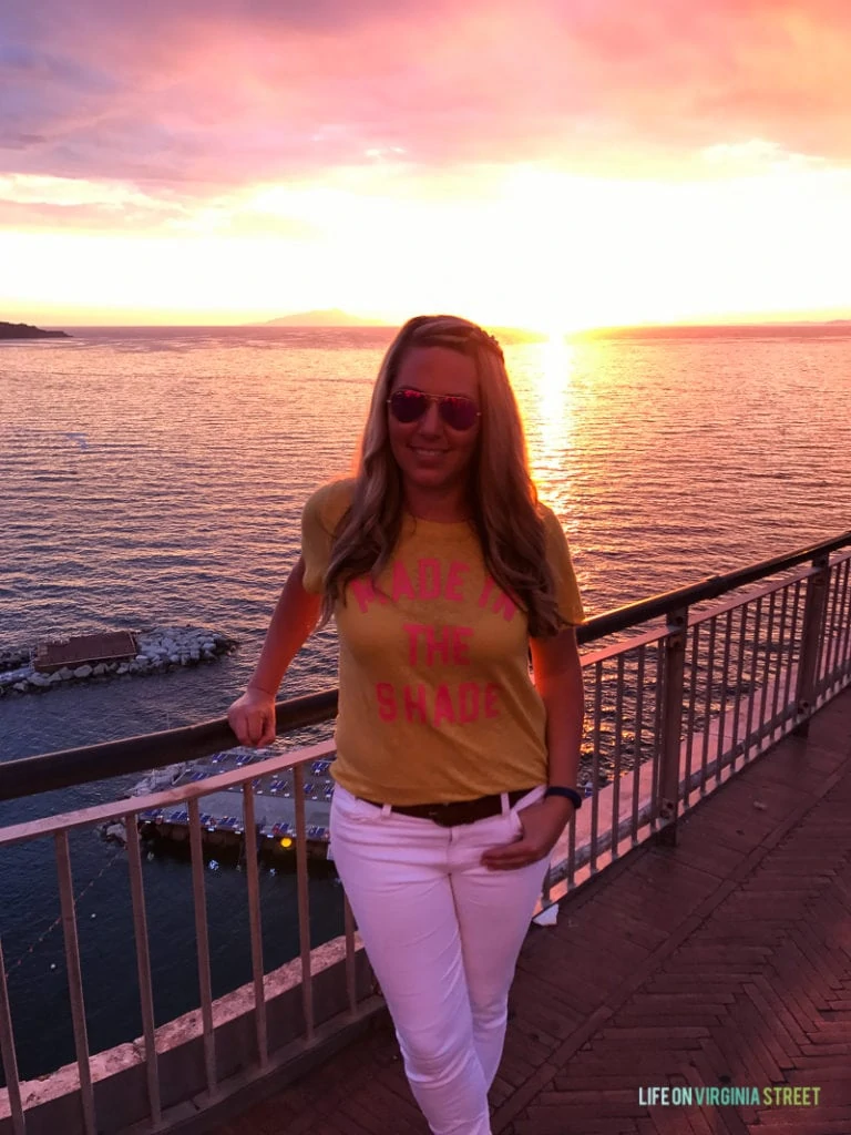 Sarah in front of the sunset on a patio.