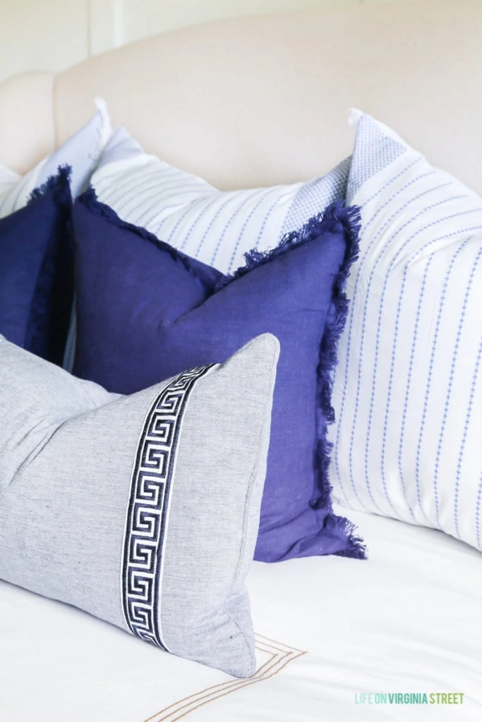 A combination of pretty blue pillows in indigo and white and blue striped pillows.