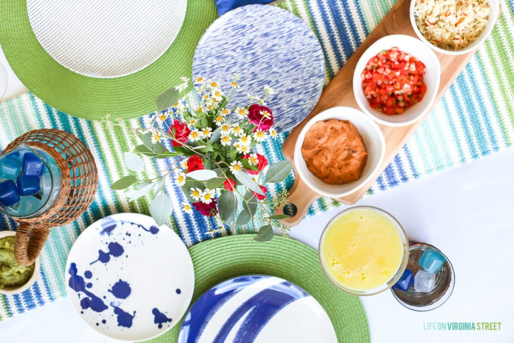 Blue and white plates, plus flowers on the table.