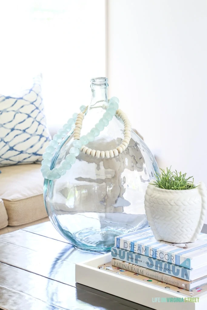 A collection of the most beautiful and favorite design coffee table books. Most are even more perfect for a coastal or beachy themed house. Love this large glass demi-john vase and glass beads!